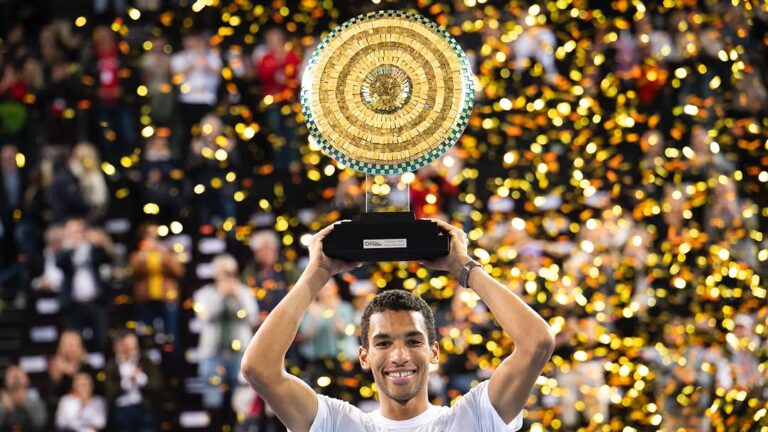 Felix Auger-Aliassime lifts the trophy, his second of 2025, in Montpellier above his head.