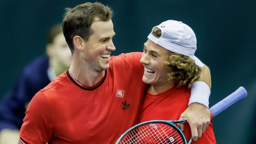 Vasek Pospisil (left) puts his arm around Liam Draxl (right) after winning their doubles match for Canada over Hungary at the Davis Cup.