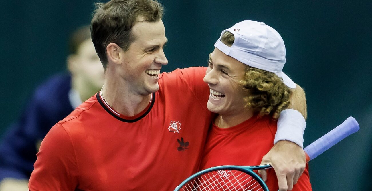 Vasek Pospisil (left) puts his arm around Liam Draxl (right) after winning their doubles match for Canada over Hungary at the Davis Cup.