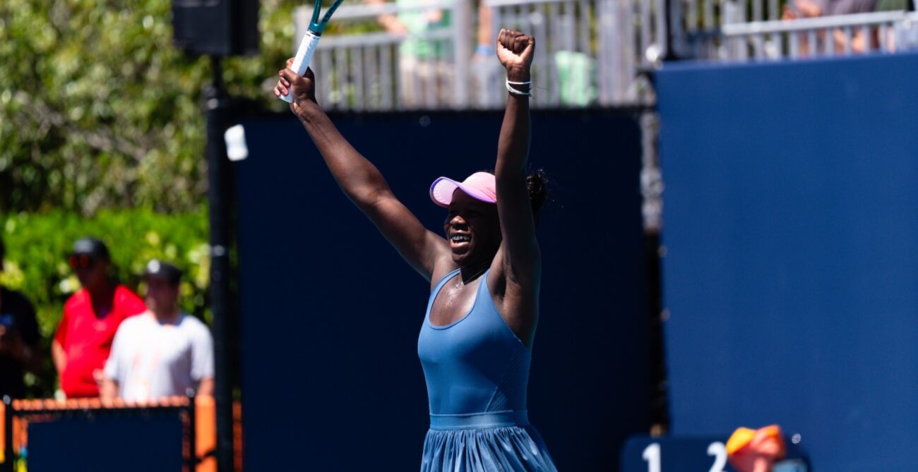 Victoria Mboko raises her arms over her head in triumph in Miami.