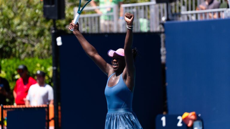 Victoria Mboko raises her arms over her head in triumph in Miami.