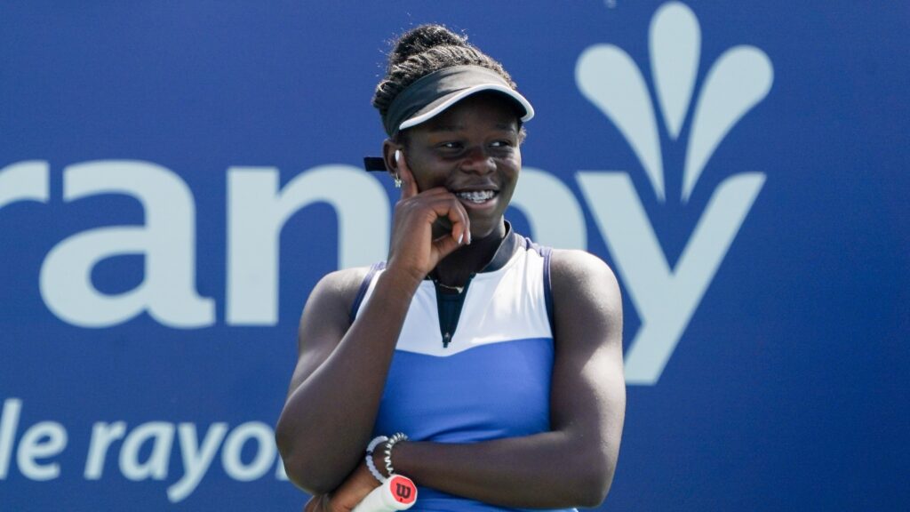 Victoria Mboko rests her hand on her face and smiles. She won 5 of her first 6 tournaments in 2025.